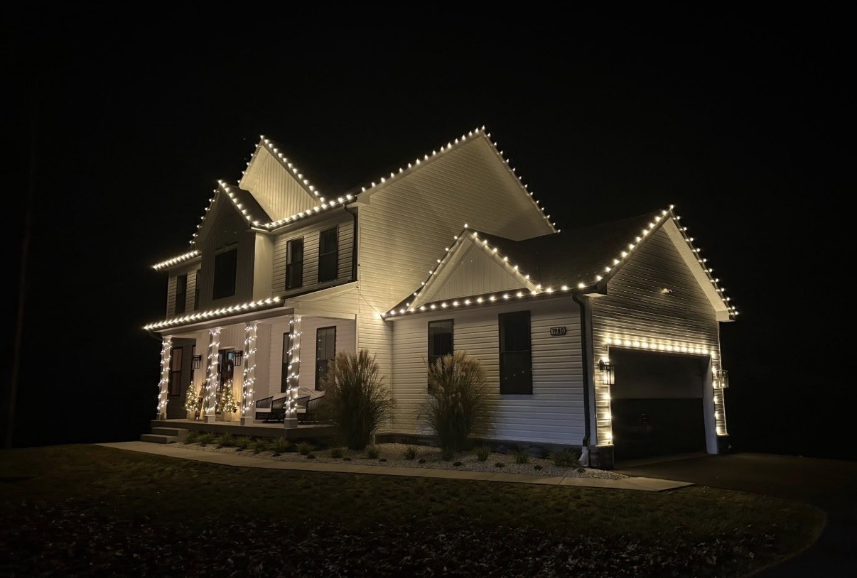O’Rileys warm white roofline and porch lights on a two-story home
